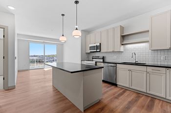 a large kitchen with an island and a large window